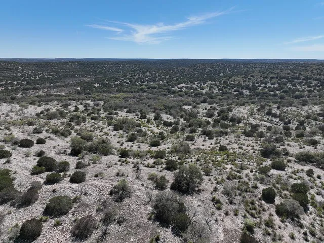 an aerial view of a houses with city view