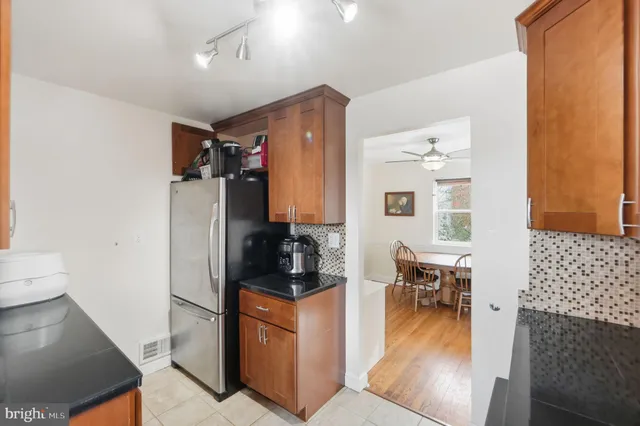 a walk in closet with wooden floor and furniture