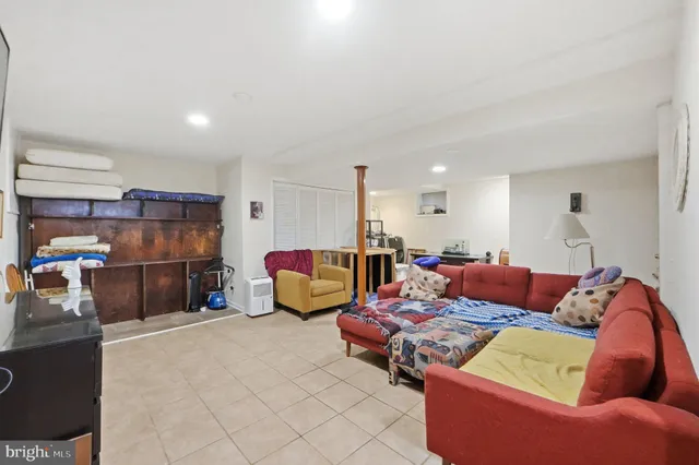 a living room with furniture a couch and a kitchen view