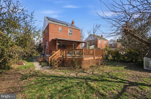 a view of deck with wooden floor and fence and trees