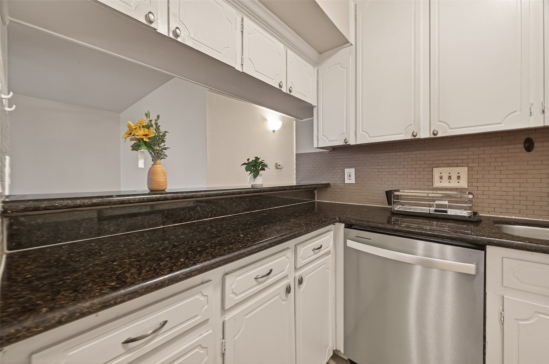 3400 Timmons Lane, Unit 31 Houston, TX 77027 - Photo 17 of 32 a kitchen with granite countertop white cabinets and white appliances