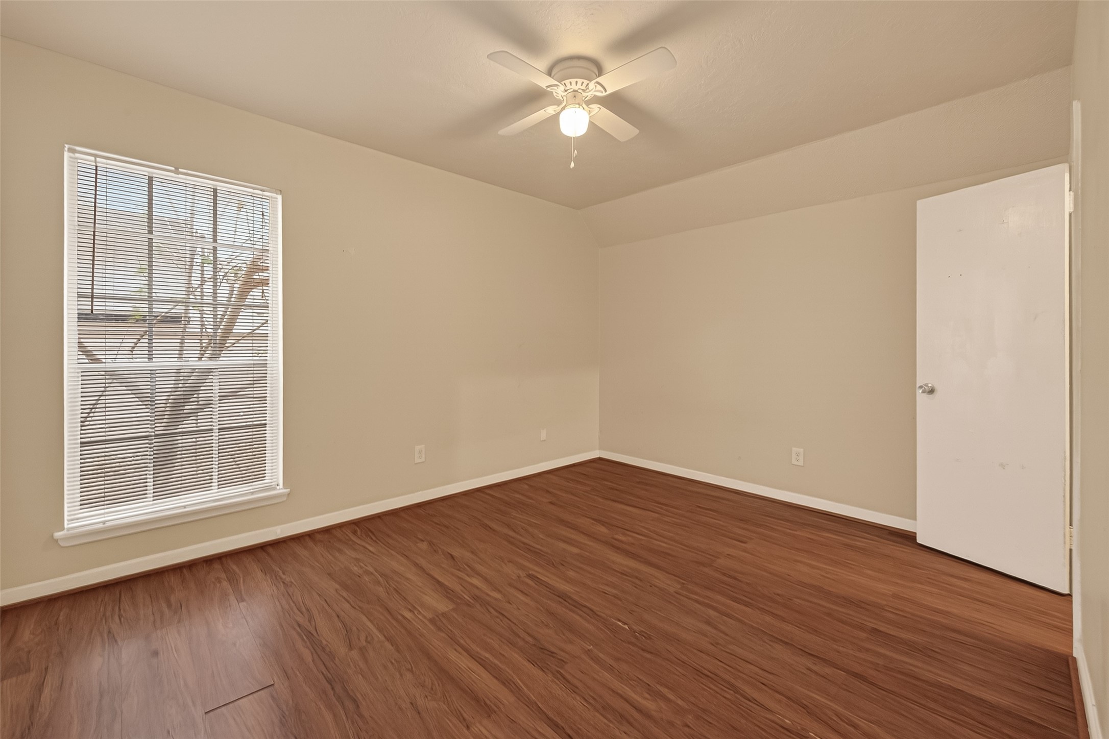 3400 Timmons Lane, Unit 31 Houston, TX 77027 - Photo 21 of 32 an empty room with wooden floor and windows