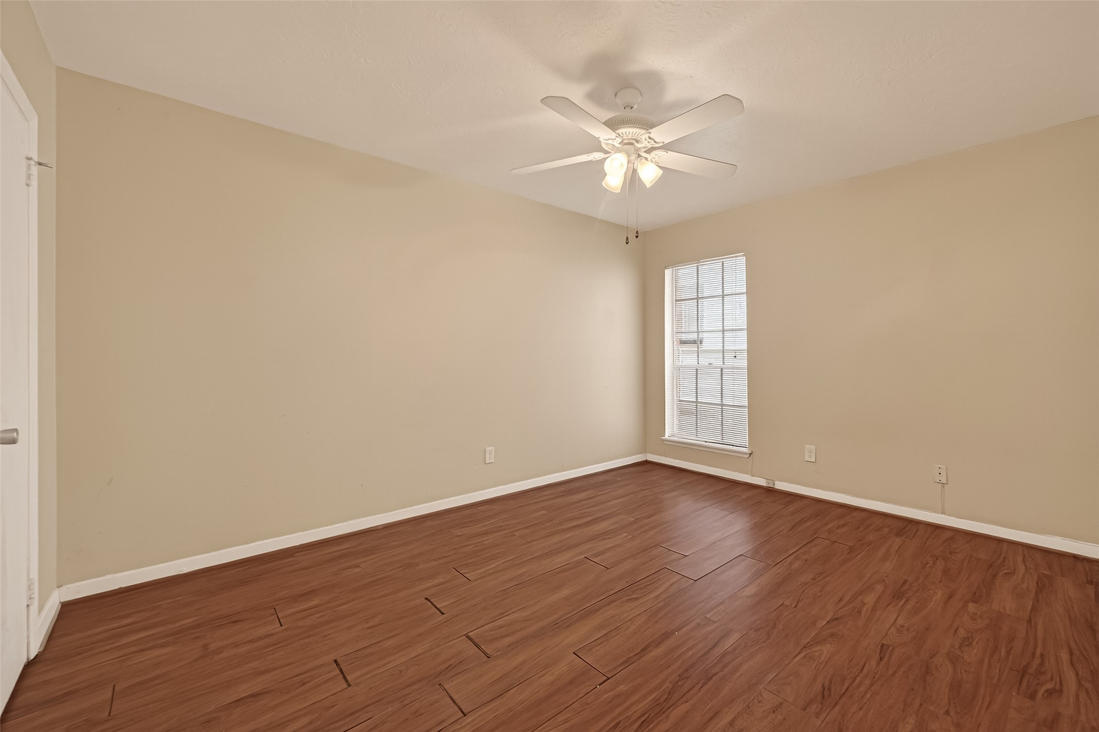 3400 Timmons Lane, Unit 31 Houston, TX 77027 - Photo 25 of 32 a view of an empty room with wooden floor and a window