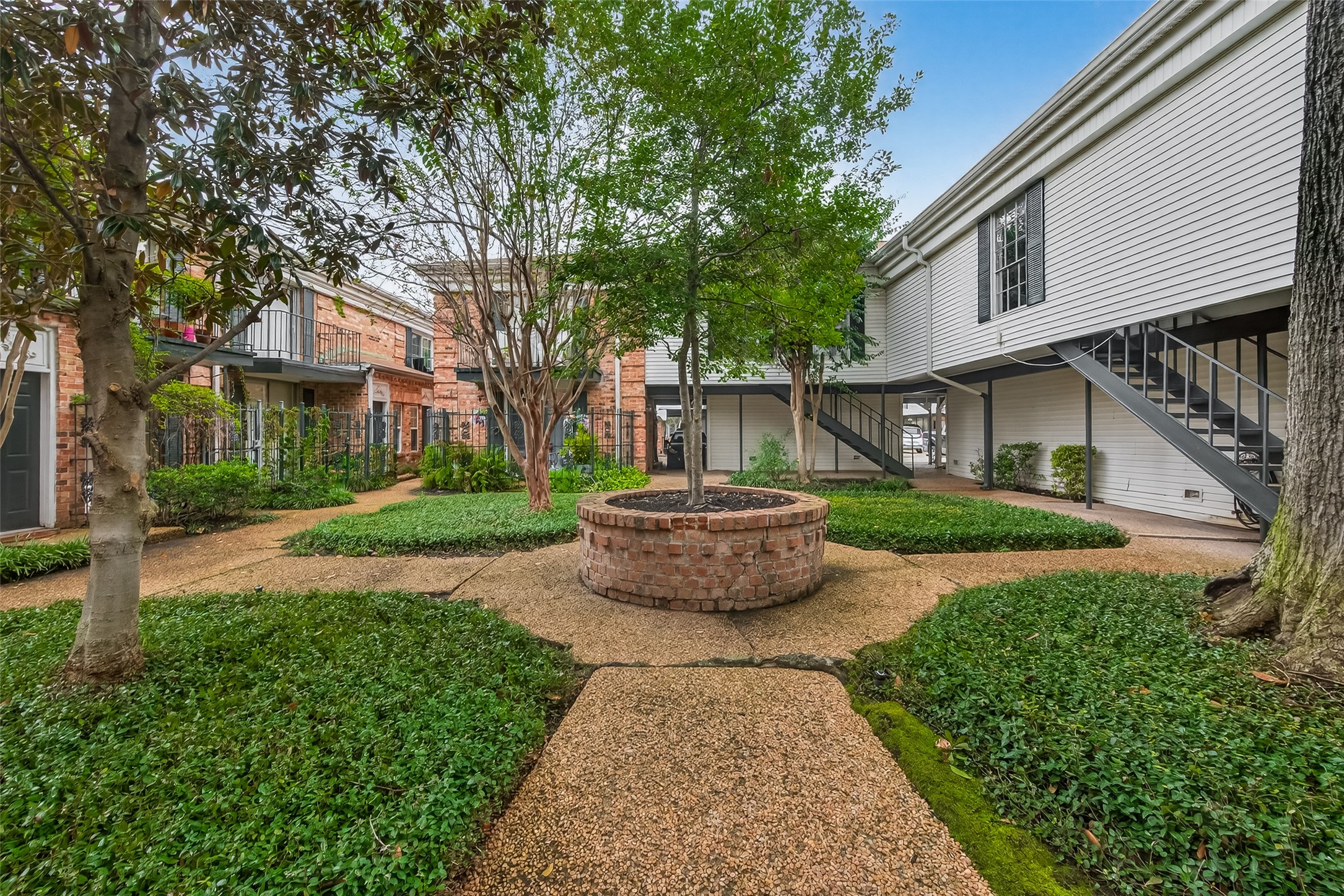 3400 Timmons Lane, Unit 31 Houston, TX 77027 - Photo 31 of 32 a front view of a house with garden and trees