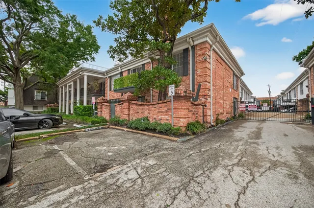 a view of a house with a yard and pathway