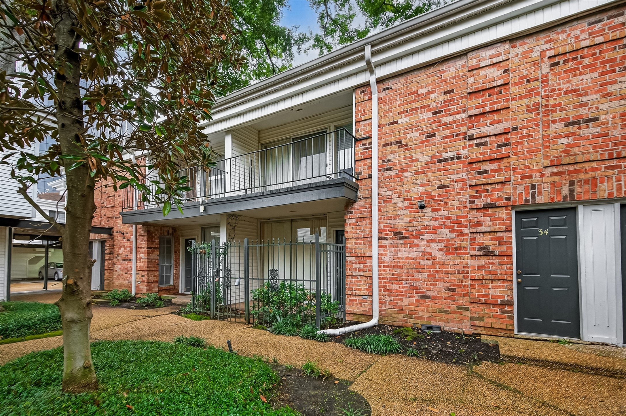 3400 Timmons Lane, Unit 31 Houston, TX 77027 - Photo 5 of 32 front view of a brick house with a large window