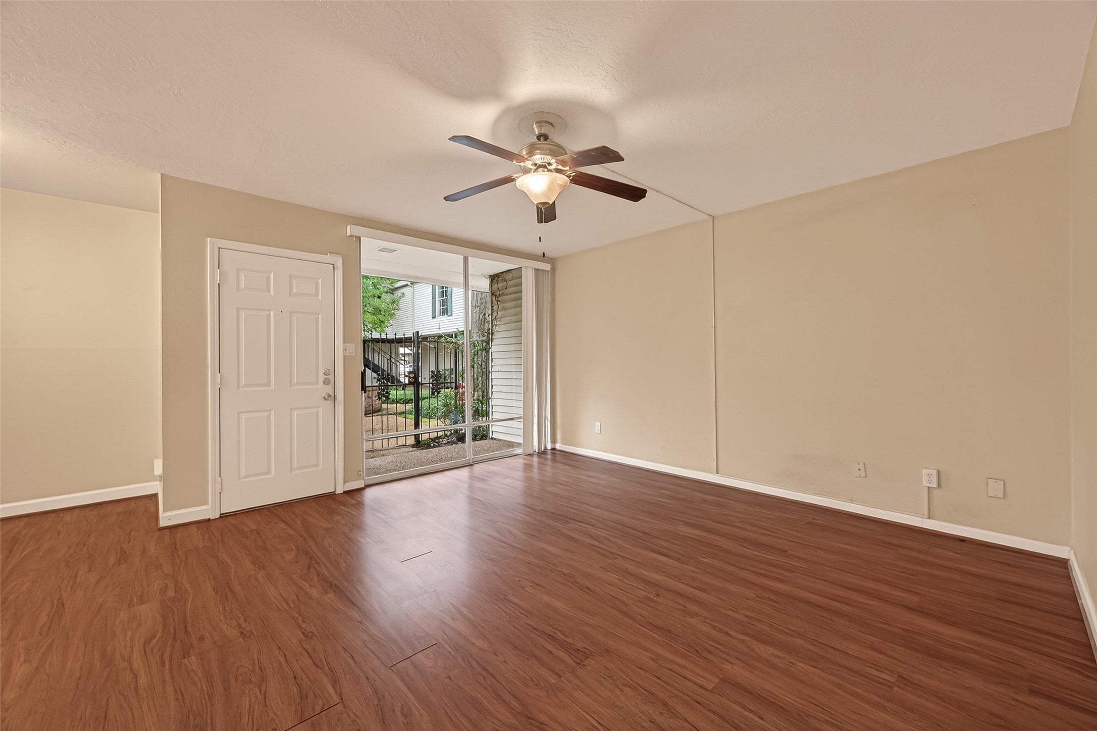3400 Timmons Lane, Unit 31 Houston, TX 77027 - Photo 8 of 32 a view of an empty room with wooden floor ceiling fan