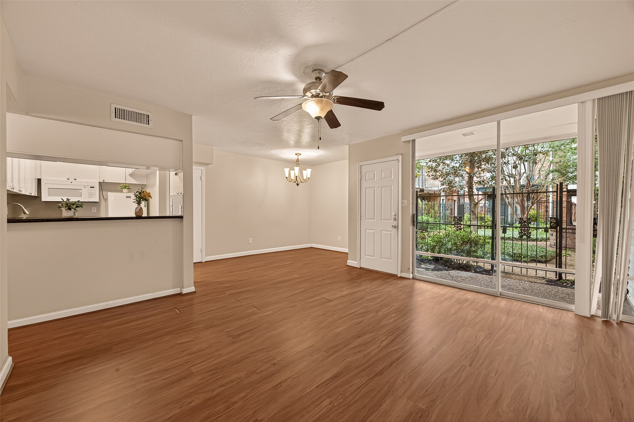 3400 Timmons Lane, Unit 31 Houston, TX 77027 - Photo 9 of 32 a view of an empty room with wooden floor and a window