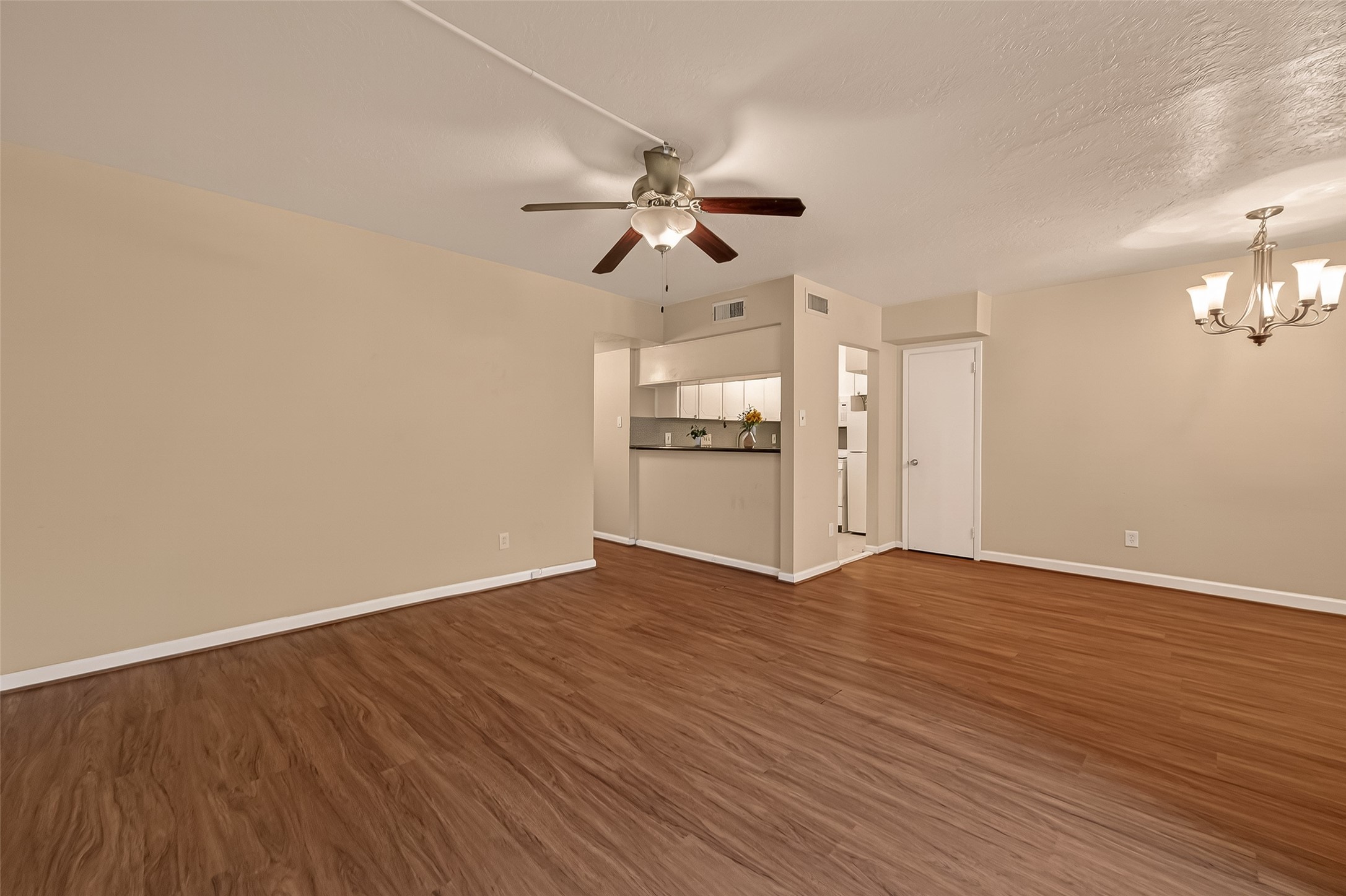 3400 Timmons Lane, Unit 31 Houston, TX 77027 - Photo 10 of 32 an empty room with wooden floor ceiling fan and windows