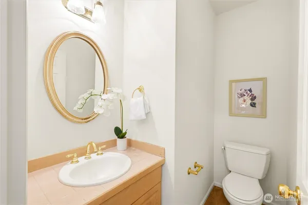 a bathroom with a toilet a sink and a mirror