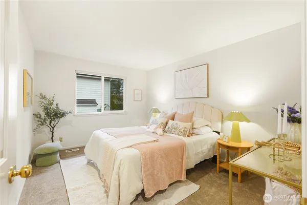 a bedroom with bed and a potted plant