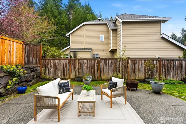 a view of a chairs and table in the back yard of the house