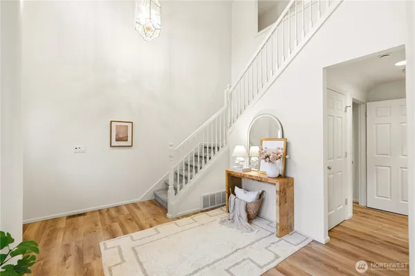 a view of entryway and hall with wooden floor