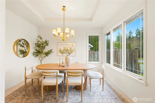 a dining room with chandelier table and chairs