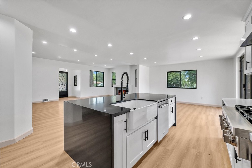 5090 Rockledge Drive Riverside, CA 92506 - Photo 15 of 40 a large kitchen with stainless steel appliances lots of counter space and wooden floor