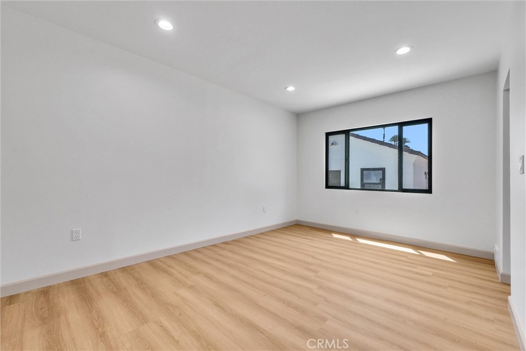 5090 Rockledge Drive Riverside, CA 92506 - Photo 17 of 40 a view of an empty room with wooden floor and a window