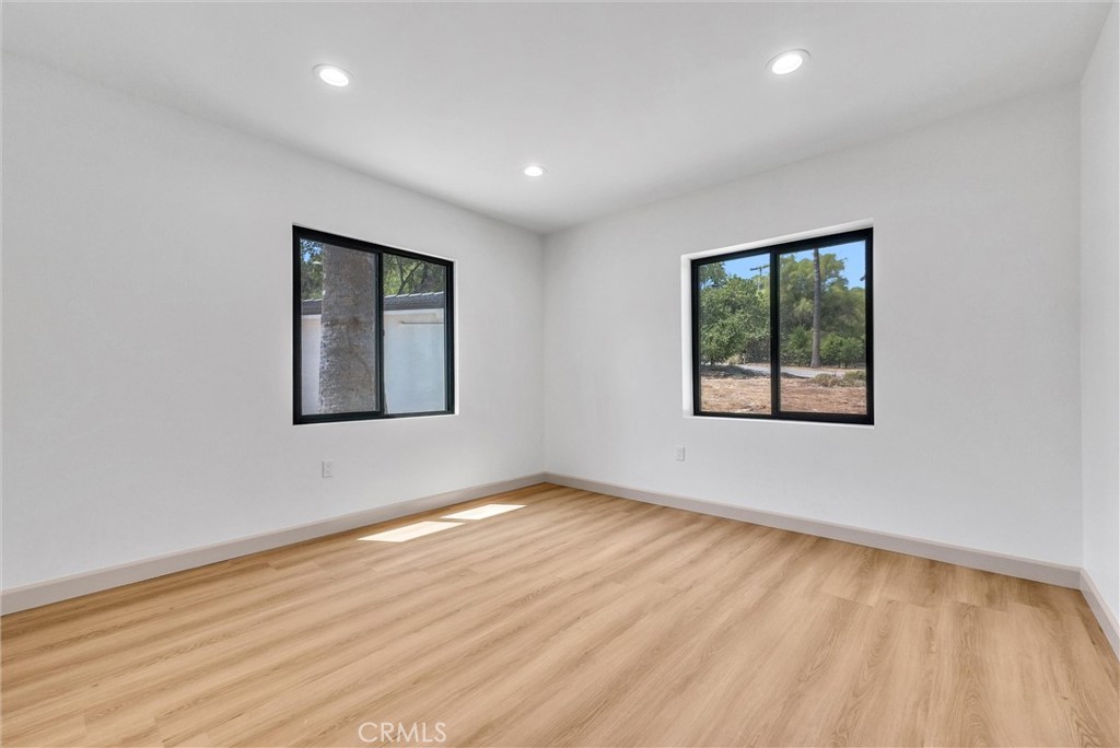 5090 Rockledge Drive Riverside, CA 92506 - Photo 20 of 40 an empty room with wooden floor and windows