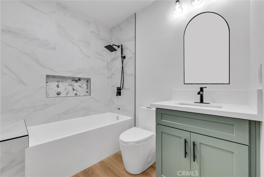 5090 Rockledge Drive Riverside, CA 92506 - Photo 23 of 40 a bathroom with a sink a toilet and a bathtub