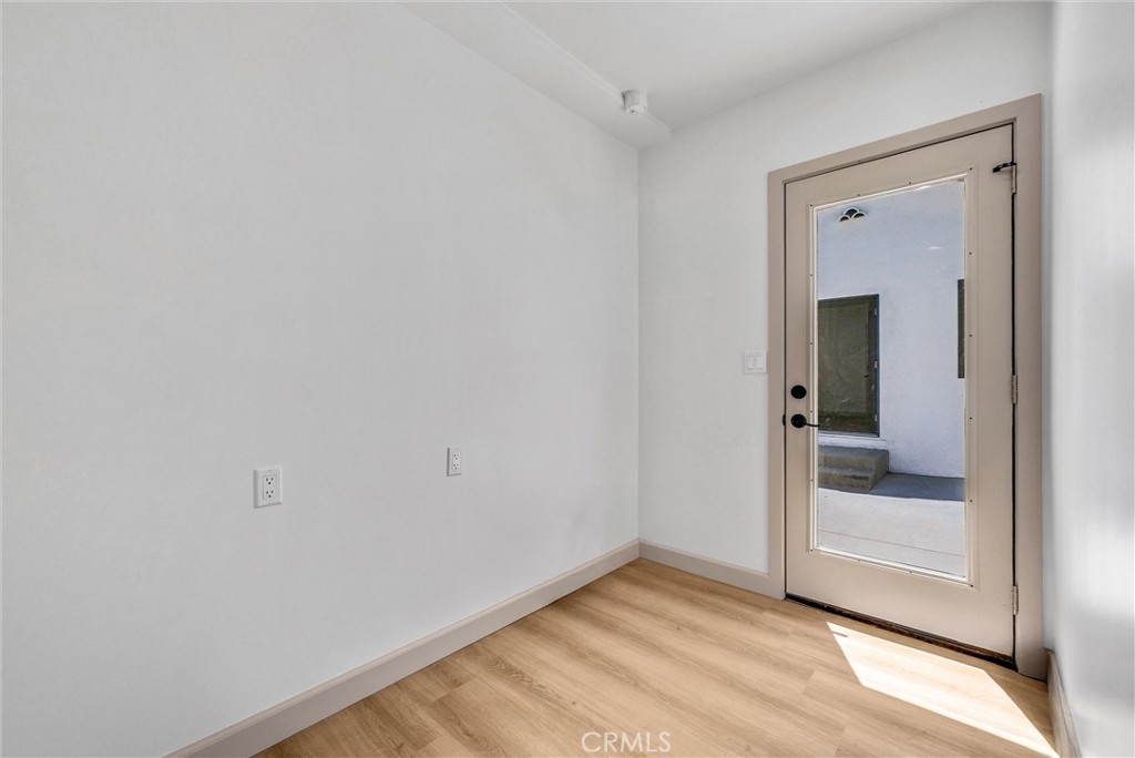 5090 Rockledge Drive Riverside, CA 92506 - Photo 27 of 40 a view of a room with wooden floor and a hallway