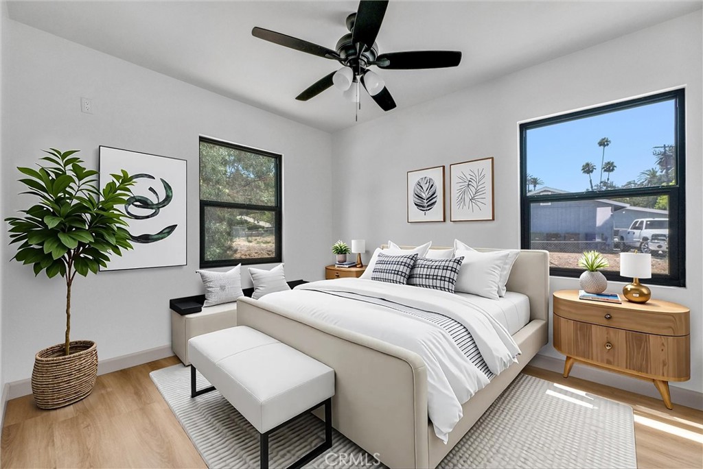 5090 Rockledge Drive Riverside, CA 92506 - Photo 33 of 40 a bedroom with a bed a bookshelf and a potted plant