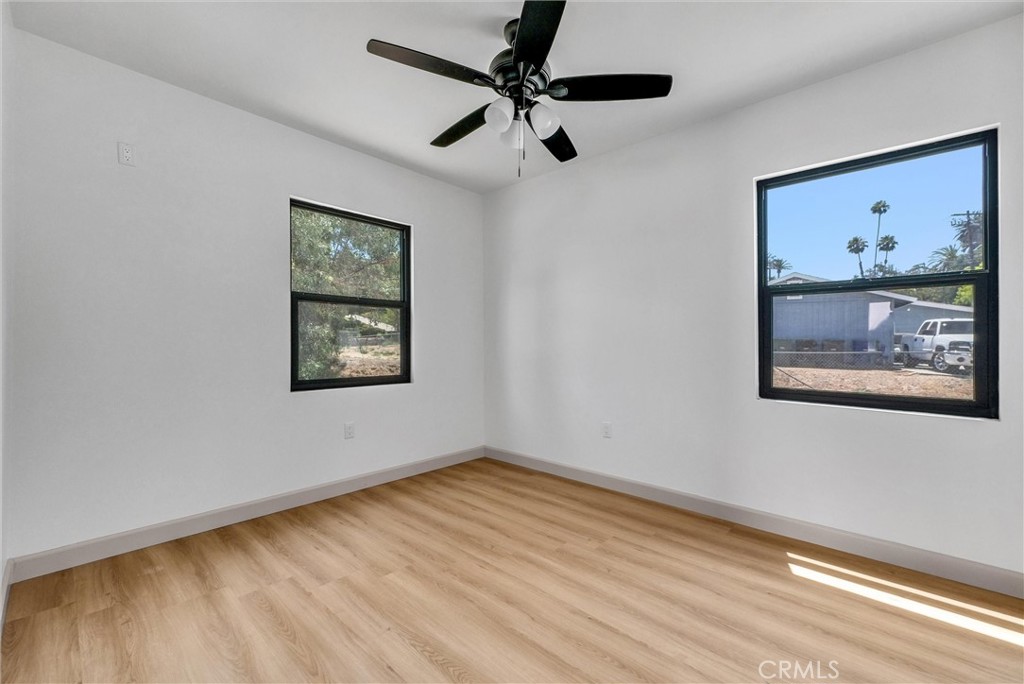 5090 Rockledge Drive Riverside, CA 92506 - Photo 34 of 40 a view of an empty room with a window and a painting on the wall