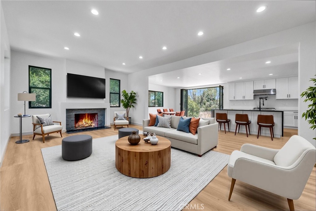 5090 Rockledge Drive Riverside, CA 92506 - Photo 6 of 40 a living room with furniture a fireplace and a flat screen tv