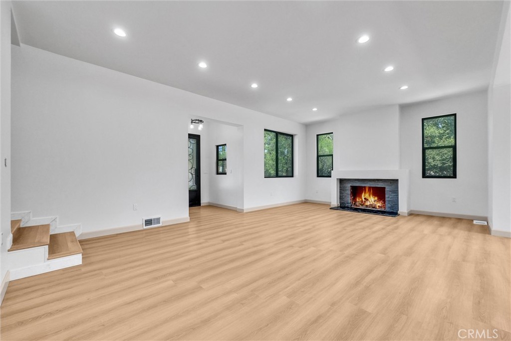 5090 Rockledge Drive Riverside, CA 92506 - Photo 7 of 40 a view of empty room with wooden floor and fireplace