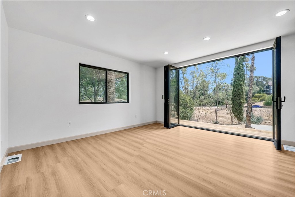 5090 Rockledge Drive Riverside, CA 92506 - Photo 10 of 40 a view of an empty room with wooden floor and a window