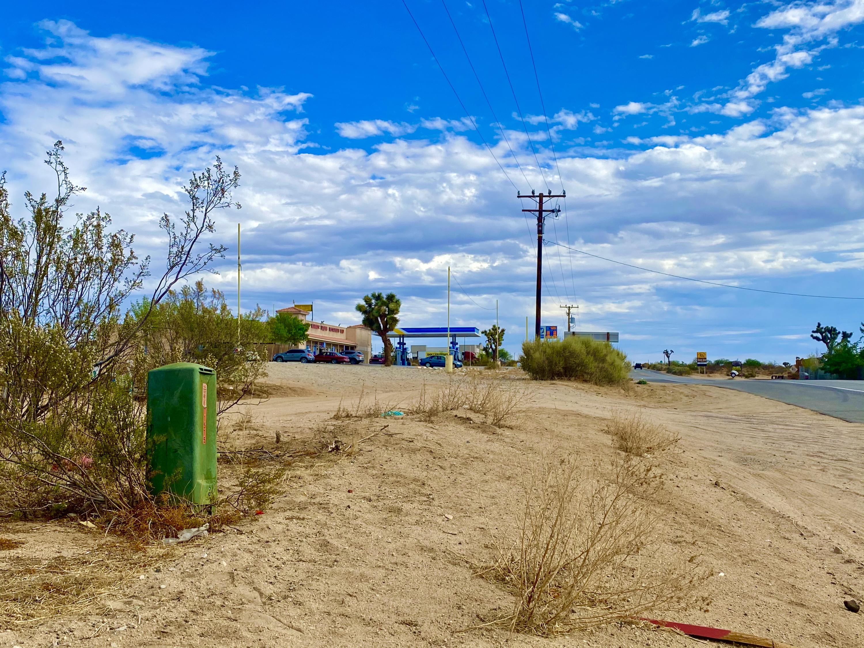 152 Old Woman Springs Road Yucca Valley, CA 92284 - Photo 28 of 32 a view of a road with a building in the background