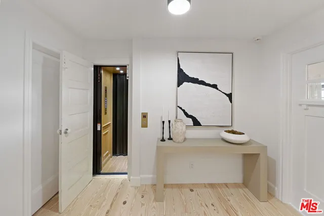 a kitchen with a checkered floor and white cabinets