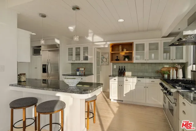 a kitchen with stainless steel appliances a sink a stove and a refrigerator
