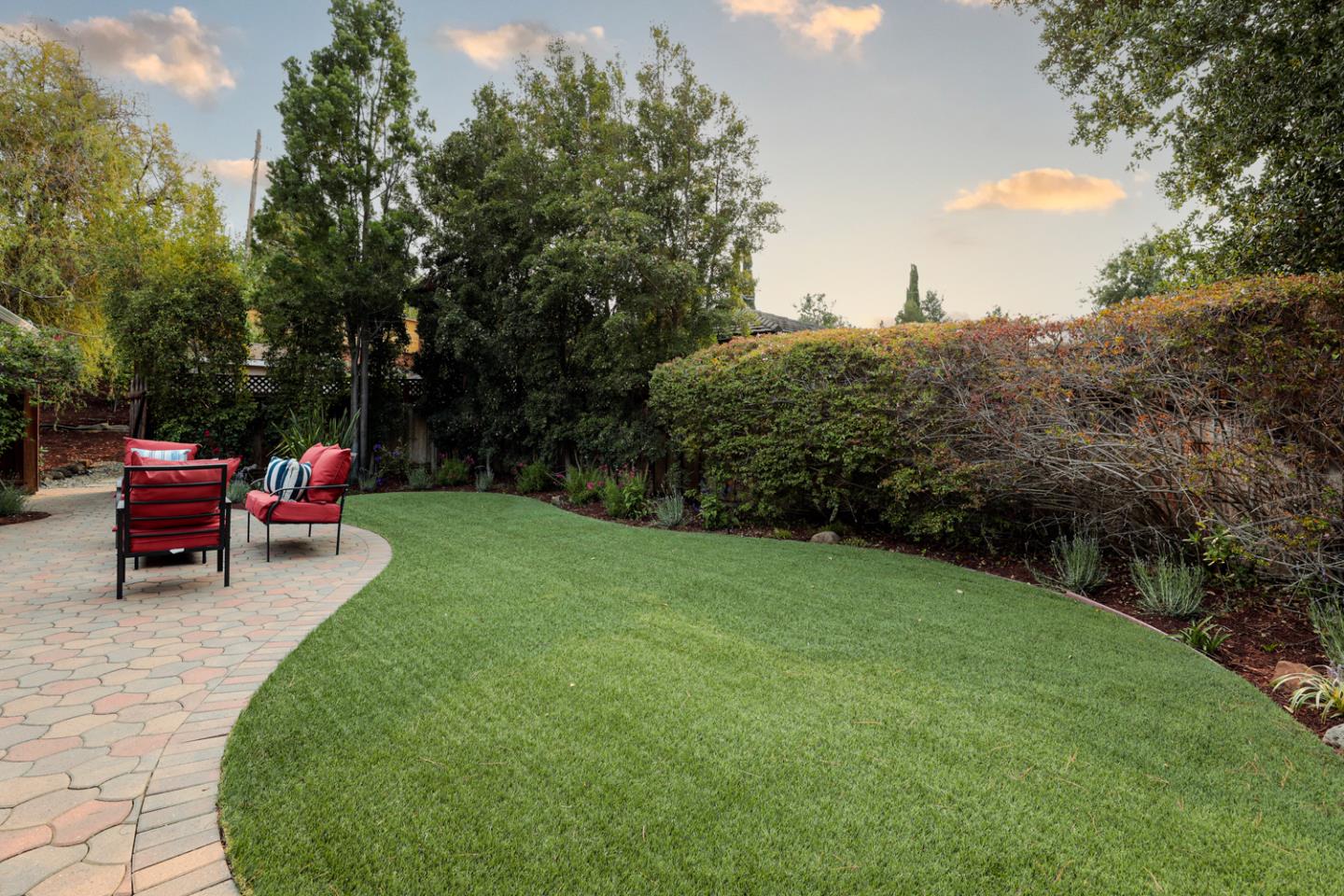 2250 Vía Maderos Los Altos, CA 94024 - Photo 23 of 36 a view of a backyard with lawn chairs under an umbrella