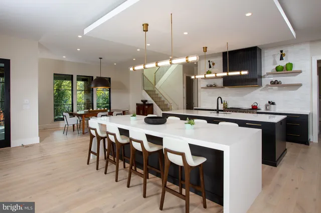 a large kitchen with a table and chairs