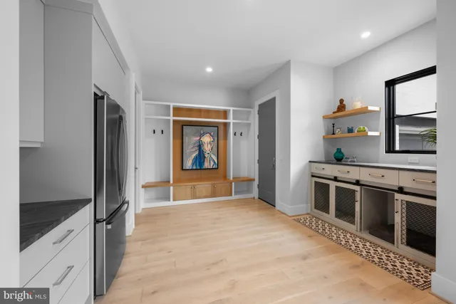 a large kitchen with stainless steel appliances granite countertop a refrigerator and a stove top oven