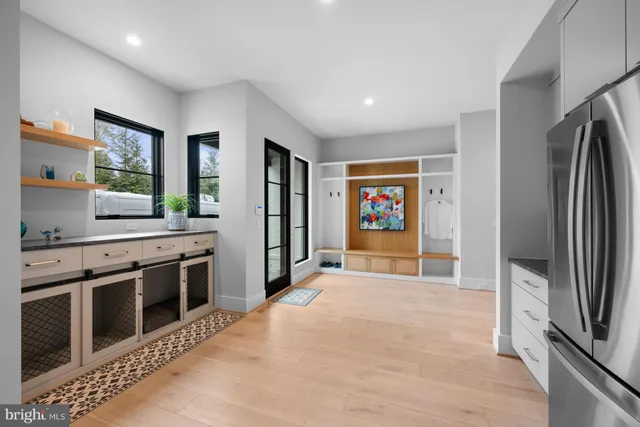 a view of a hallway with stairs and wooden floor