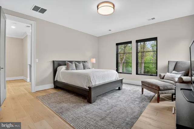 a bedroom with a bed and a large window