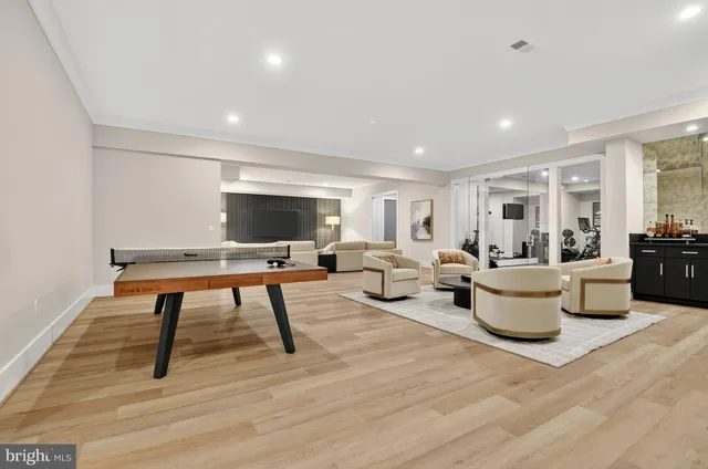 a living room with furniture and a large mirror