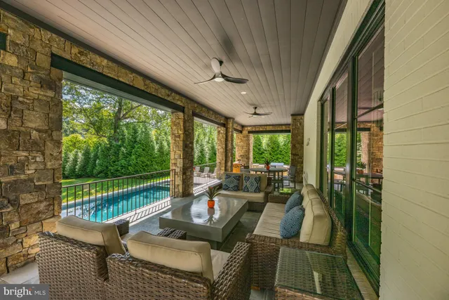 a view of a patio with table and chairs with a barbeque grill and plants