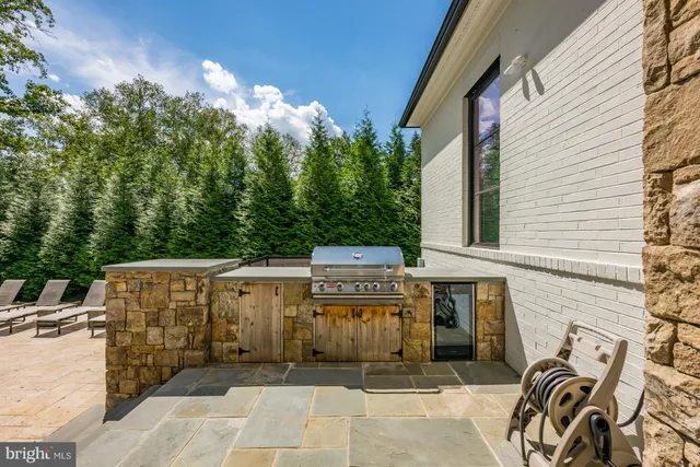 a view of a house with patio and a garden