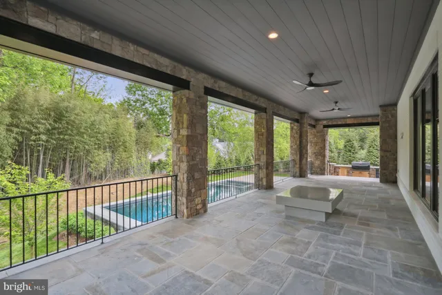 a view of a patio with chairs and plants