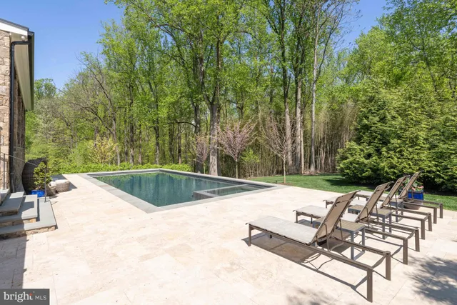 an aerial view of a house with yard swimming pool and outdoor seating
