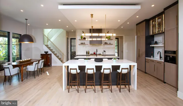 a large kitchen with a table and chairs