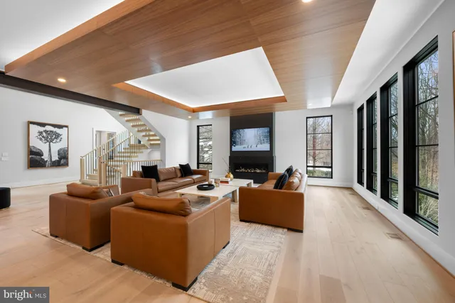 a living room with furniture a large window and a flat screen tv
