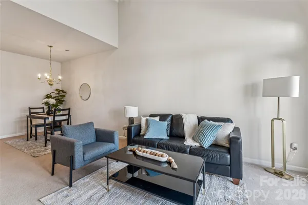 a living room with furniture and a chandelier