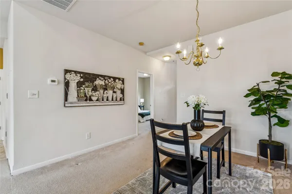 a view of a dining room with furniture and chandelier