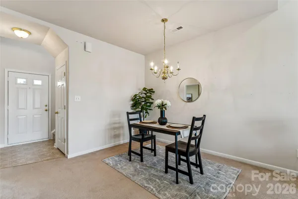a view of a dining room with furniture and chandelier