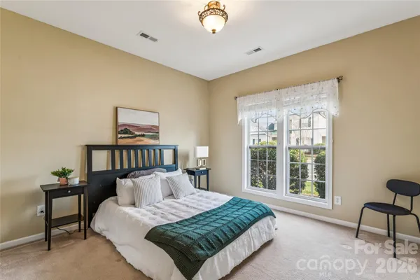 a spacious bedroom with a large bed and a window