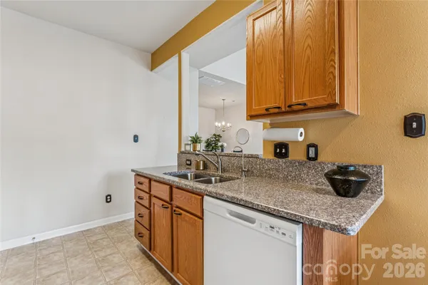 a kitchen with stainless steel appliances granite countertop a sink and cabinets