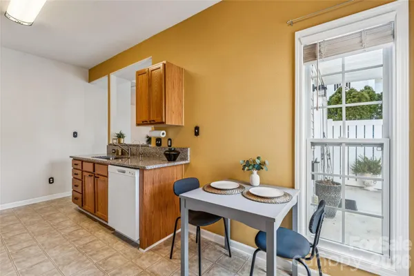a kitchen with a sink cabinets and dining table
