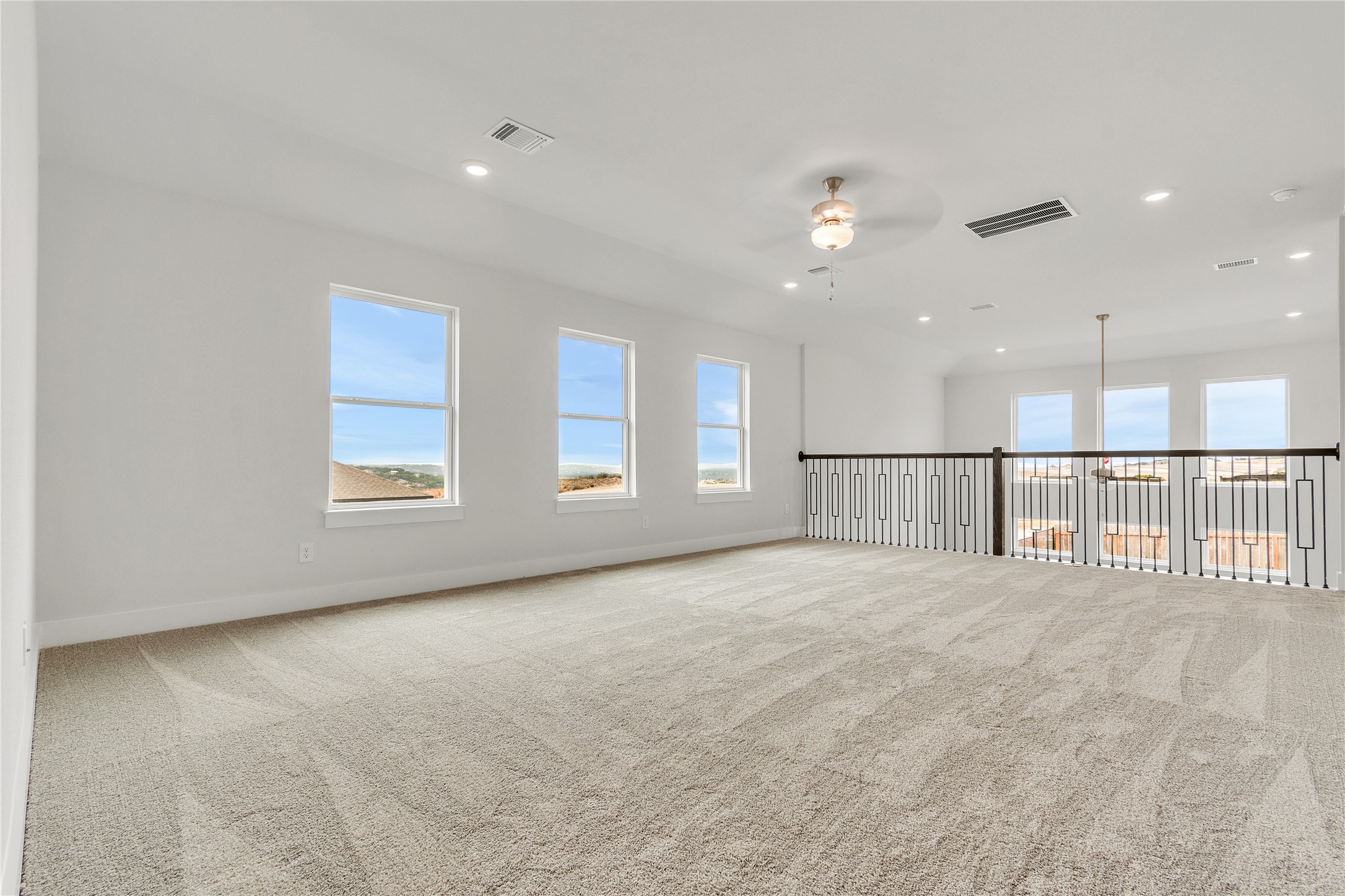 8500 Red Bottle Brush Road Lago Vista, TX 78645 - Photo 14 of 33 A spacious upper-level area offers multiple windows and plush carpet.